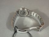 an image of a wrist watch with a tag attached to it