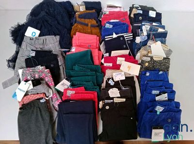 many pairs of pants that are stacked on top of each other