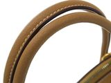 a close up of the handle of a brown handbag on a white background