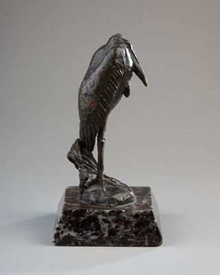 statue of a pelican on a rock on a white background