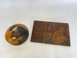 a small wooden plaque with a picture of a man on it