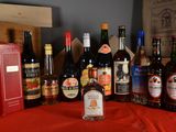 many bottles of alcohol sitting on a red table