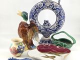 a blue and white vase with a bird on it and a plate with a bird on it