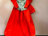 a red dress hanging on a hanger on a wall