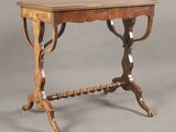 an old wooden table with a wooden top and a wooden base