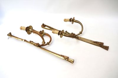 three antique brass handles and handles on a white surface
