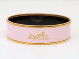 a close up of a pink and gold ring with a horse drawn on it