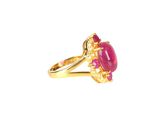 a close up of a pink stone ring on a white background