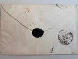 an old envelope with a stamp on it sitting on top of a table