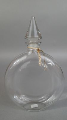 a clear glass bottle with a rope wrapped around it