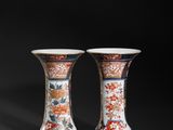 pair of chinese vases on a black background with a black background