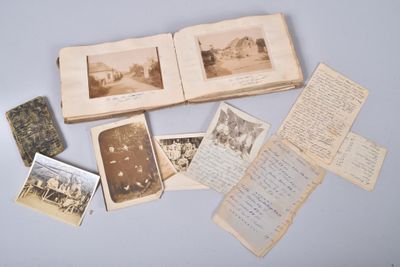 an open book with old photos and old letters on a table