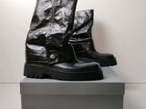a pair of black boots sitting on top of a box
