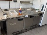 a kitchen with a sink and a refrigerator in it