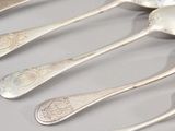 several spoons and spoon spoons are lined up on a table