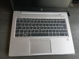 a laptop computer sitting on a table with a keyboard