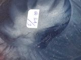 a blue hat with a tag on it sitting on a table
