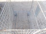 a metal cage that has a dog inside of it