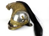 a silver helmet with a long black hair on it