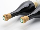 two bottles of wine sitting next to each other on a table