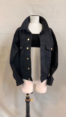 a black jacket on a mannequin stand on a white background