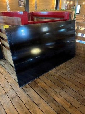 a wooden bench with a red seat in the middle of a room