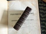 an old book with a bookmark on top of it
