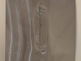 a picture of a piece of metal on a white surface