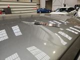 a car that is parked in a garage with other cars in the background