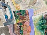 many different colored drawings on the table together