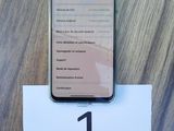 an iphone is sitting on top of a table with a number 1 on it