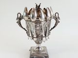 a silver bowl with spoons and spoons in it