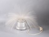 a white feather on top of a silver object