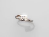 a close up of a diamond ring on a white surface