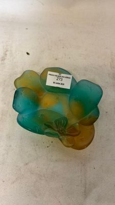 a glass bowl with a label on it sitting on a table
