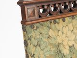 a close up of a chair with a floral upholstered back