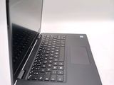 a laptop computer sitting on a table with a keyboard