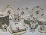 a lot of plates and cups that are sitting on a table