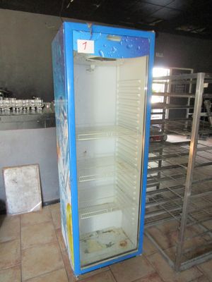 an empty refrigerator in the middle of a room