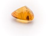 an orange diamond on a white surface with a white background