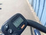 a close up of a bicycle ' s handlebar with a clock on it