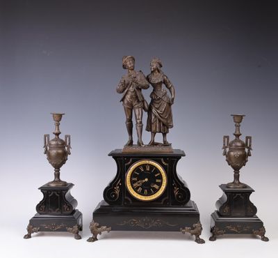 three different types of clocks on display on a table