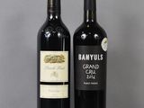 two bottles of wine sitting next to each other on a table