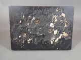 a picture of a black marble block with holes in it