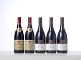 six bottles of wine are lined up on a table