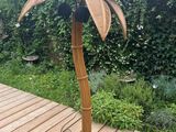 a lamp that has a palm tree on top of it