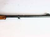 a rifle with a wooden barrel and a wooden handle