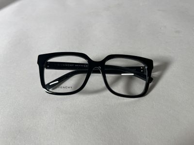 the glasses are black and have clear lenses on them
