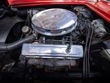 a red car engine with the hood up and the hood down
