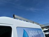 an image of a van parked in a parking lot with a sign on the side of it